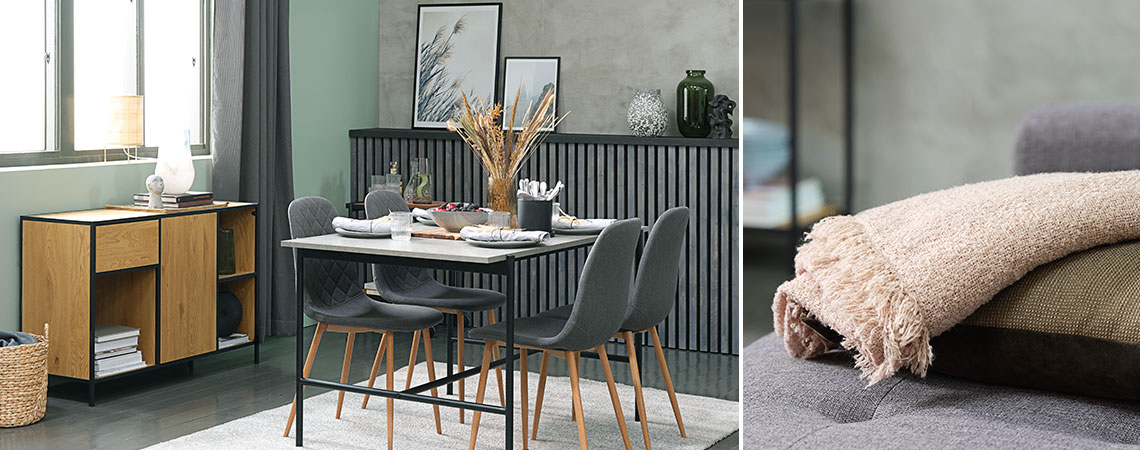 Olohuone, jossa on betonityylinen ruokapöytä, harmaat ruokapöydän tuolit ja tamminen senkki