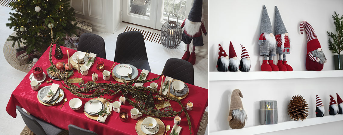 Ruokapöytä, joka on koristeltu jouluun joulukuusella ja tontuilla