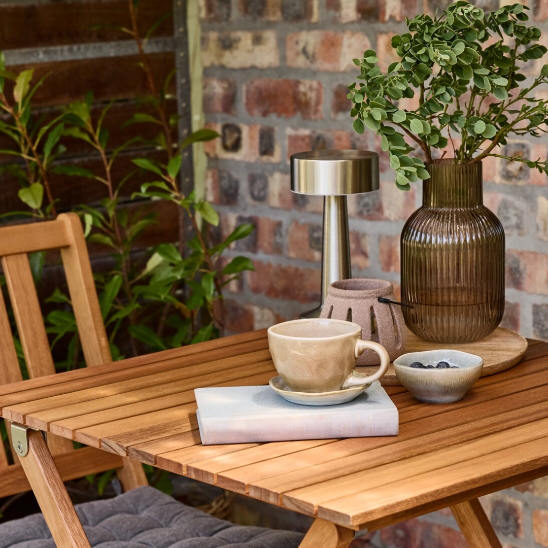Table setting with DETMER coffee cup, YNGVAR vase and MUSVIT table lamp