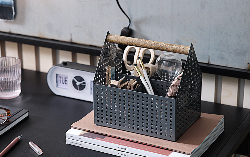 Open storage box with handle, containing scissors, pens, pegs Open storage box with handle, containing scissors, pens, pegs