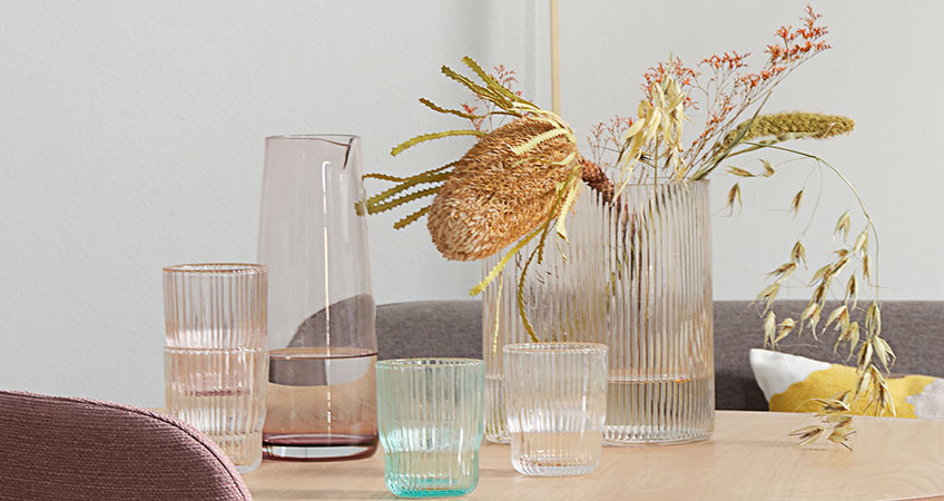 UNO jug, HILMIR vase and CLAES drinking glasses Jug, drinking glasses, and vases all in coloured glass