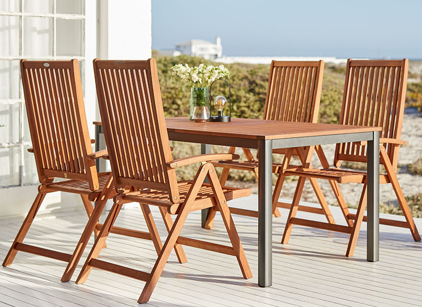 Wooden garden furniture on a patio by the ocean