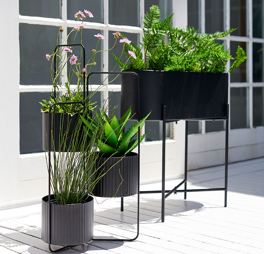 Istutuslaatikko ja kasvien ruukkupidike aurinkoisella patiolla