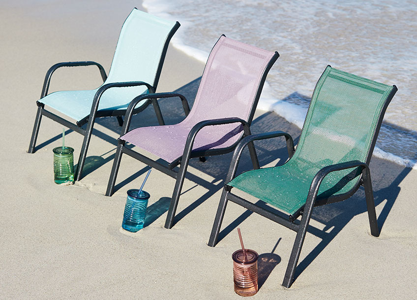 LEKNES children’s stacking chair and ALF drinking cup Children’s stacking chair on a beach with a drinking cup placed in front of each one