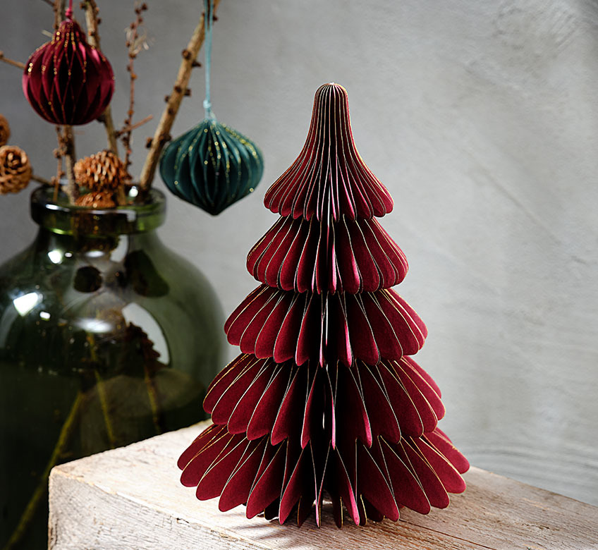Large glass vase and small deep-red mini Christmas tree in paper