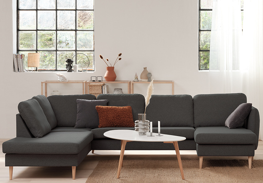 Large sofa with chaise longue and open-end. In the middle a small coffee table 