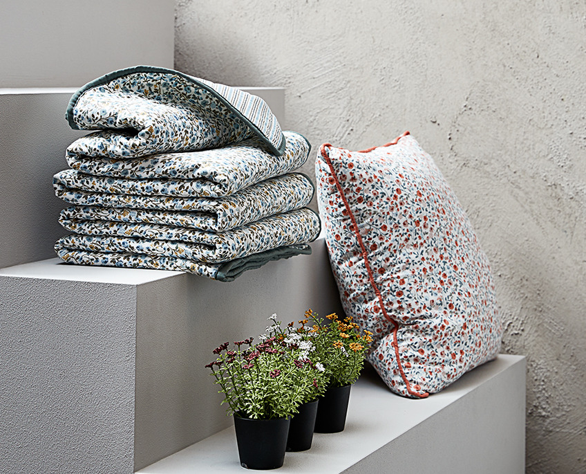 FLORA throws and cushion and KALLE artificial flowers Staircase with floral throws and a cushion and three faux flowers