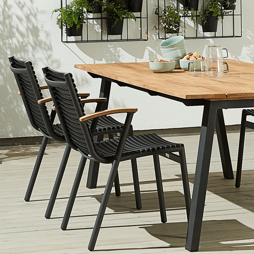 SADBJERG stacking chair with seat and backrest out of recycled ocean plastic and armrest out of FSC certified teak Garden stacking chairs with seat and backrest out of recycled ocean plastic
