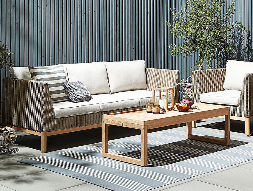 GLAMSBJERG lounge set in polyrattan and teak. The lounge table is made entirely out of recycled teak Garden lounge set with a lounge table out of recycled teak