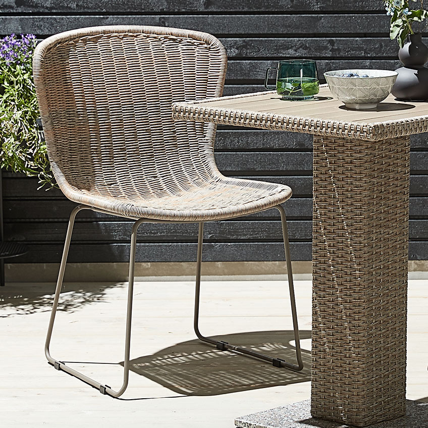 HAJSTRUP garden chair and THY bistro table Garden chair with a natural look, made of polyrattan and metal with a bistro table made of polyrattan on a patio