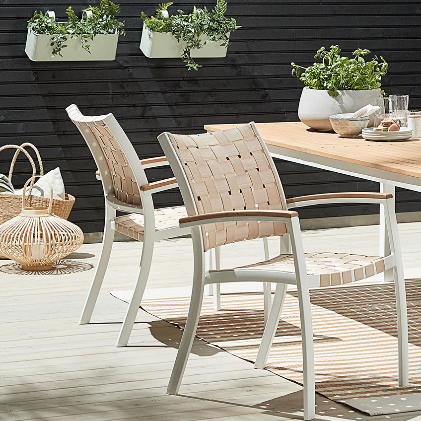 JEKSEN stacking chair and RAMTEN garden table Light garden stacking chairs and garden table on a patio