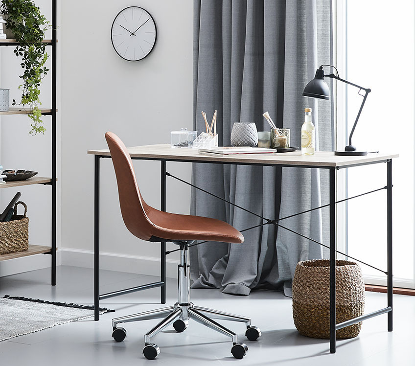 Stylish office chair in cognac faux leather at an elegant office desk