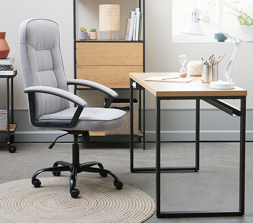 Grey fabric office chair at an office desk 