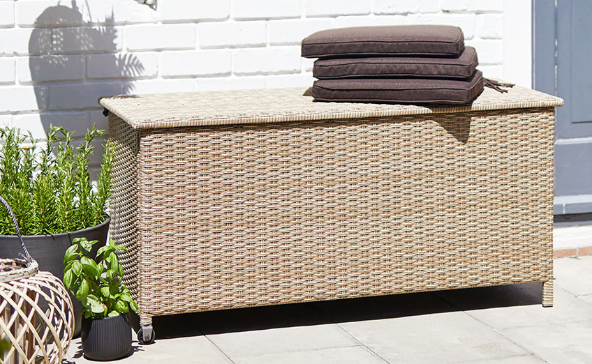 Cushion box with handle and wheels on a sunny patio 