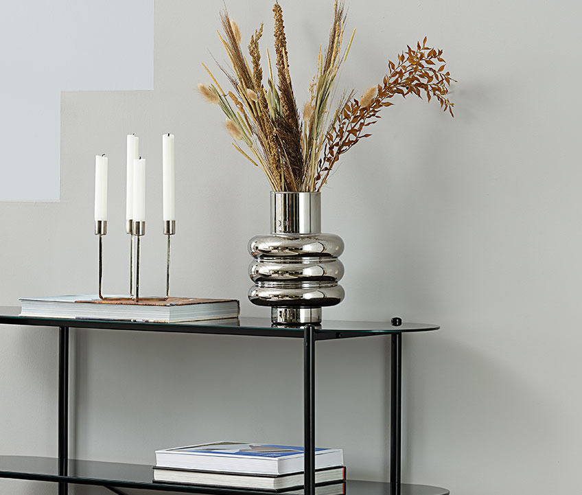 MAGNUS vase on PADBORG shelving unit Vase with silver look on a bookcase