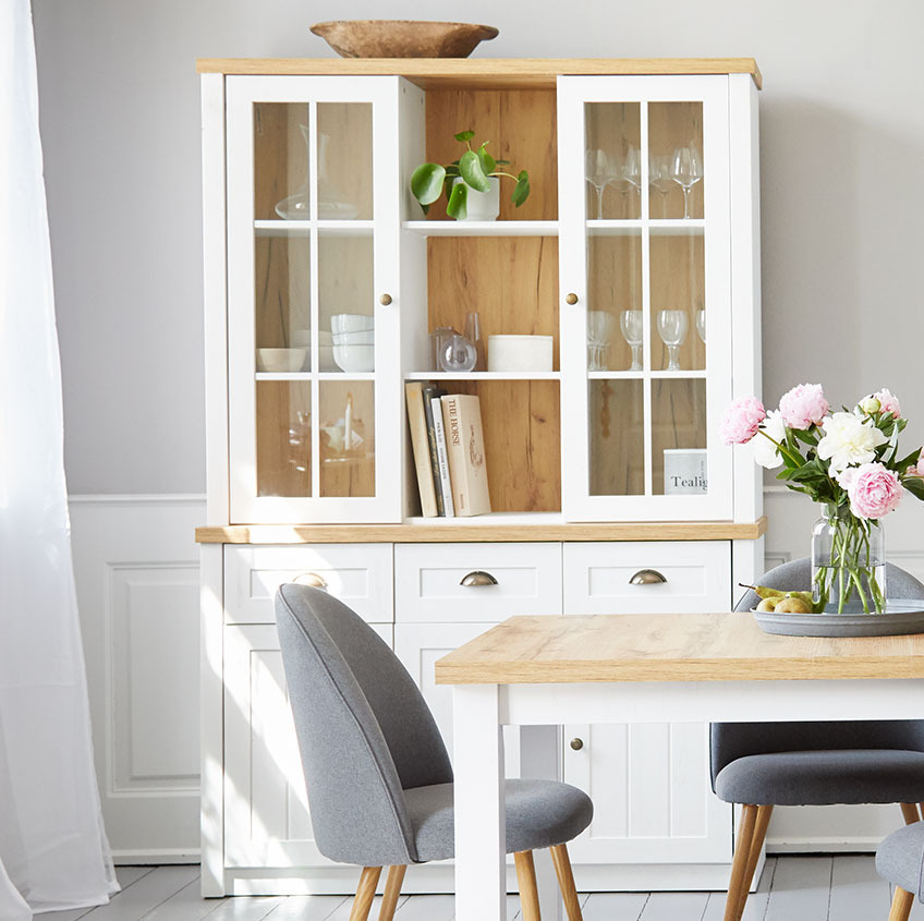 White sideboard with three doors and drawers and top with two glass doors