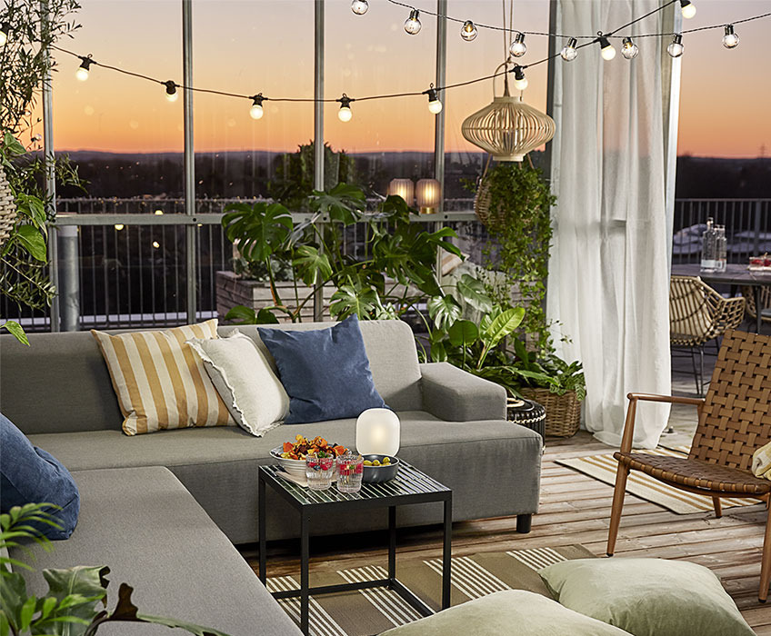 VALERIANA, DUSKULL and FJELLFIOL cushions Outdoor setting with string lights, lounge set, cushions, and lanterns
