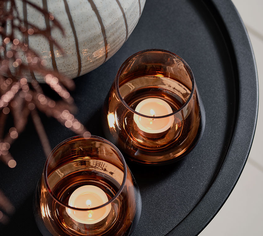 BRYNJE tealight holders on the RANDERUP end table Two tealight holders on a black end table