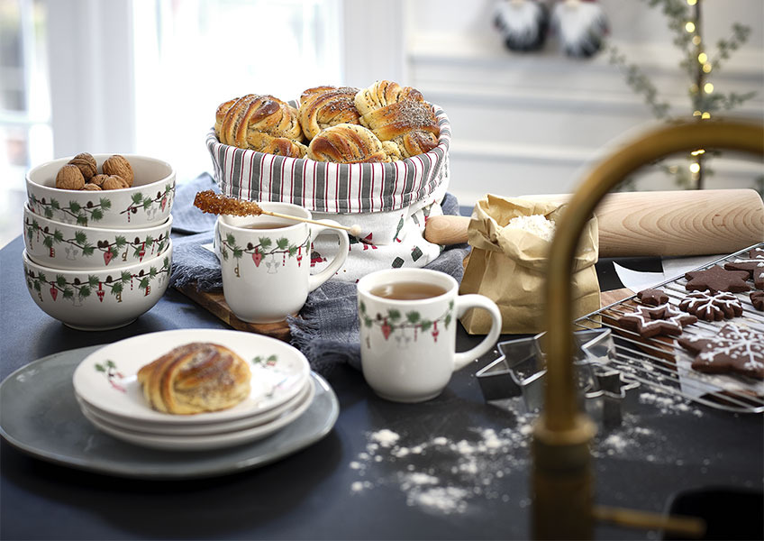 Bowls, mugs and plates with a Christmas print and home baked sweets