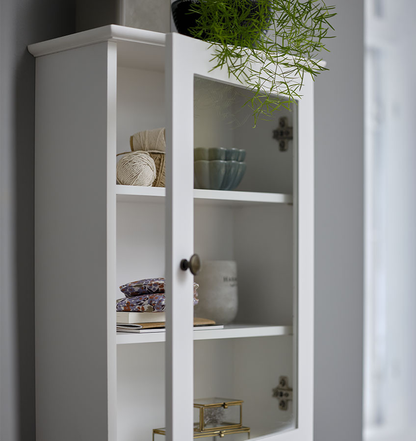 MALLING wall cabinet White wall cabinet with glass front displaying decorative items
