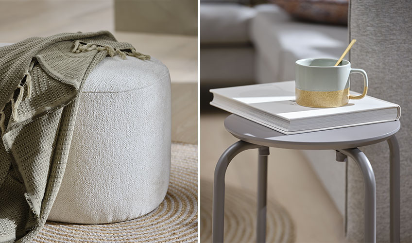Off-white pouffe with green throw and grey stool with book and mug