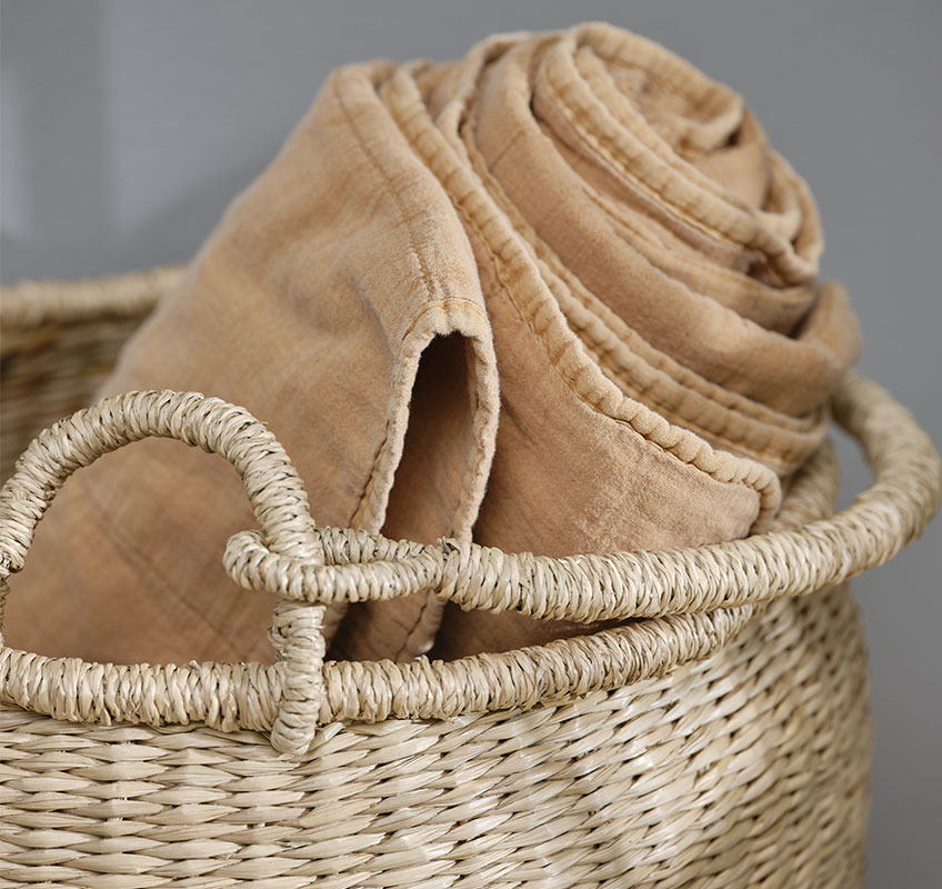 VALMUE orange blanket and BRAGE basket Wicker basket with orange quilted blanket