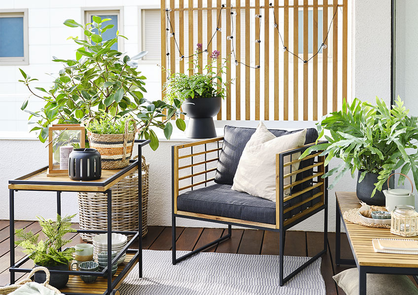 Balcony decorated with green plants in different sizes