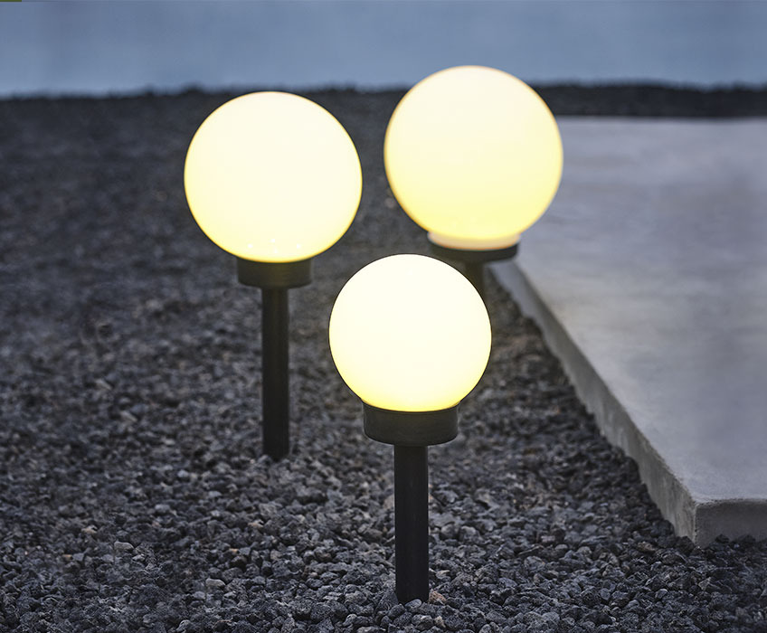 Three black and white solar lamps in round shapes
