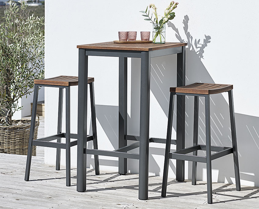 Bar table and stools on a sunny patio